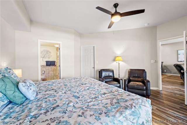 bedroom with a ceiling fan, wood finished floors, baseboards, and ensuite bathroom