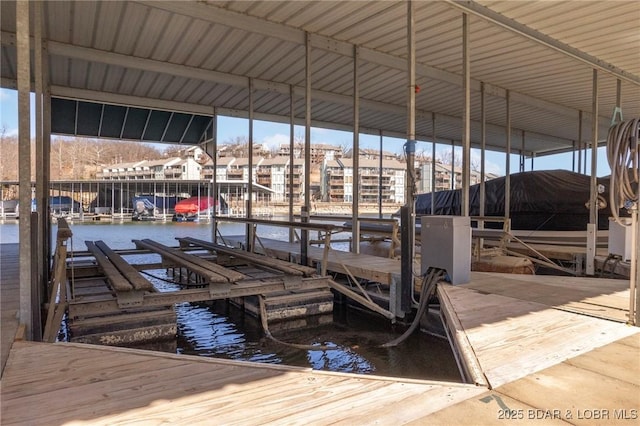 view of dock featuring boat lift and a water view