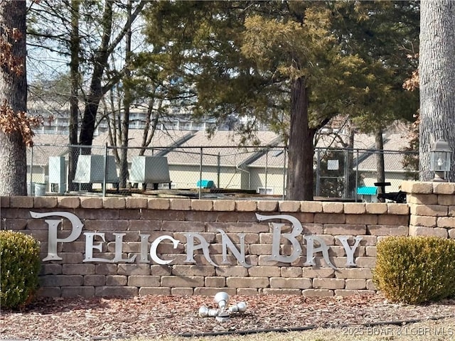 community sign featuring fence