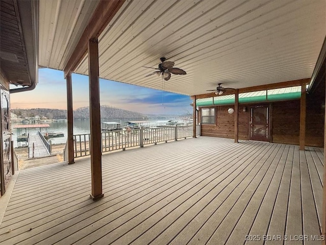 deck featuring a ceiling fan and a water view