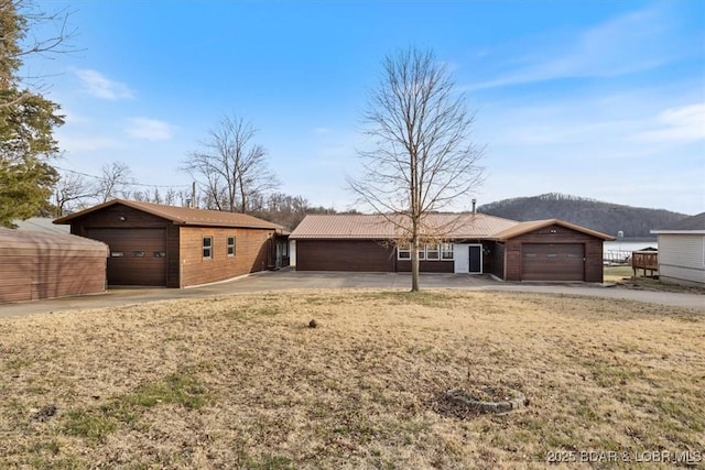 single story home with a mountain view and a garage