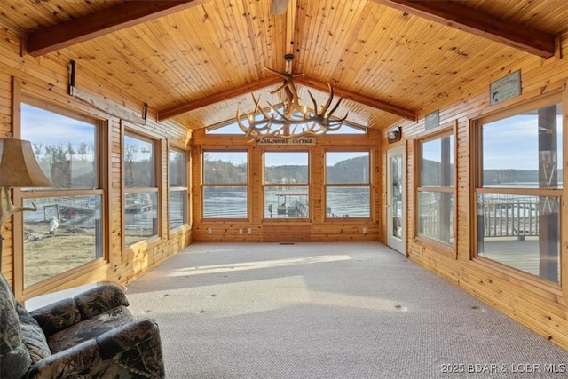 unfurnished sunroom with plenty of natural light, wooden ceiling, and vaulted ceiling with beams