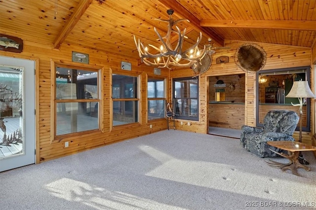 interior space featuring lofted ceiling with beams, wooden walls, a notable chandelier, and wood ceiling