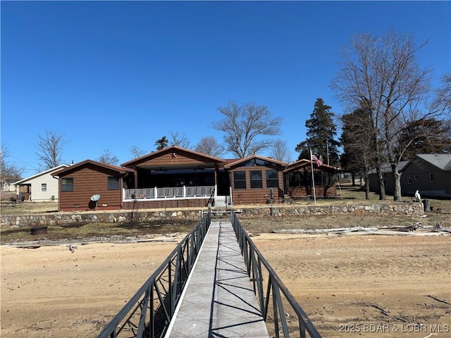 rear view of property featuring faux log siding