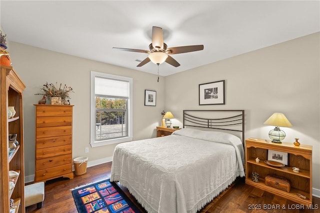 bedroom featuring ceiling fan, baseboards, and wood finished floors