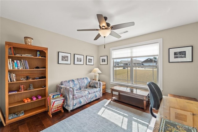 home office featuring ceiling fan, visible vents, and wood finished floors