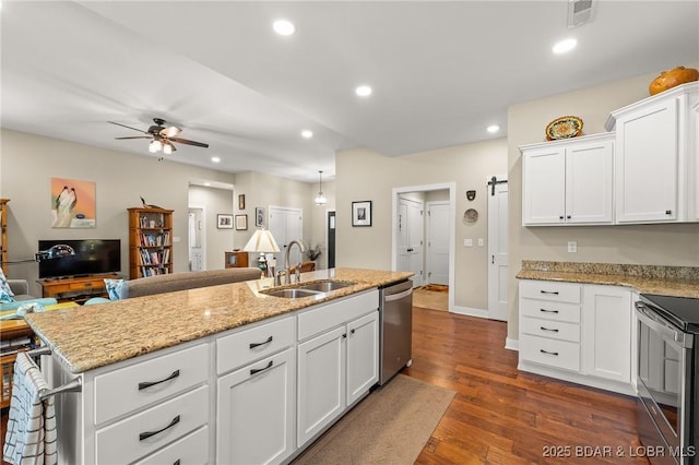 kitchen featuring visible vents, dark wood-style flooring, a sink, stainless steel appliances, and open floor plan