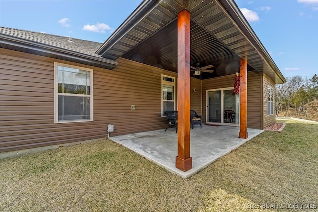 back of house featuring a patio, a lawn, and a ceiling fan