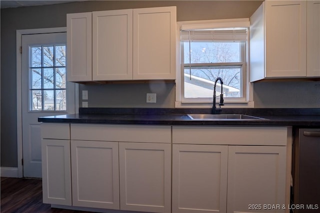 409 S Walnut St, Versailles, MO 65084 - kitchen featuring white cabinets, dark countertops, dishwasher, and dark wood-style floors