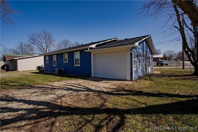 exterior space featuring central air condition unit, a lawn, and driveway