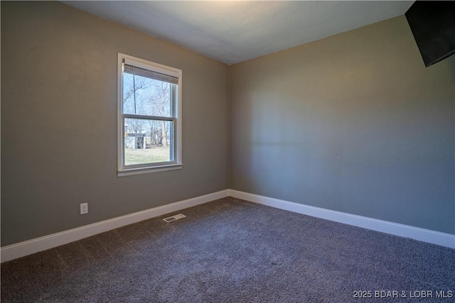 unfurnished room featuring visible vents, carpet floors, and baseboards