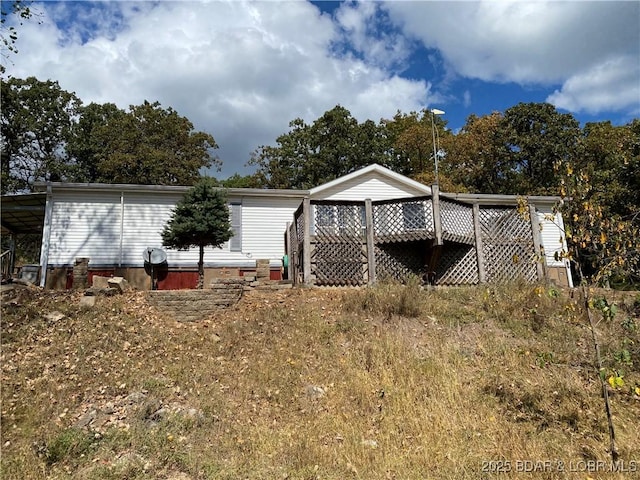 back of property with a carport