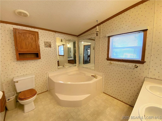 full bath with wallpapered walls, lofted ceiling, a sink, a textured ceiling, and crown molding