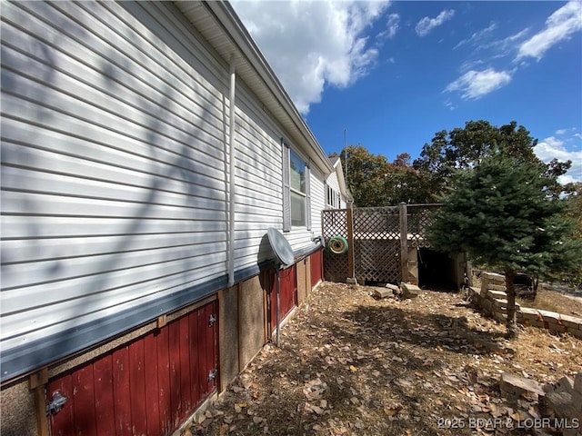 view of home's exterior with fence