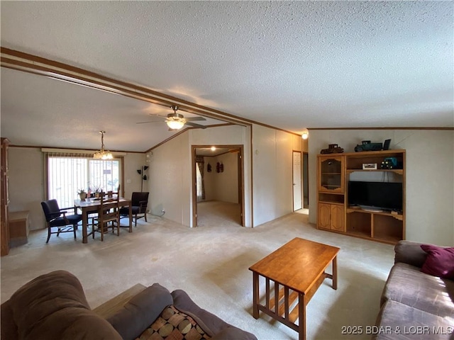 living area featuring crown molding, ceiling fan, light colored carpet, vaulted ceiling, and a textured ceiling