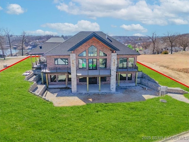 rear view of house with a yard and a patio