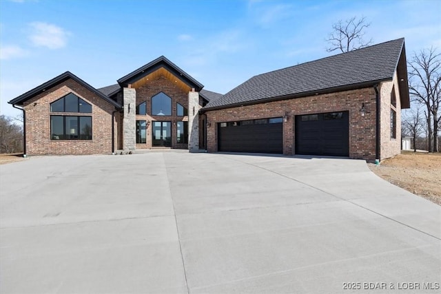 view of front of house featuring driveway, brick siding, roof with shingles, and an attached garage