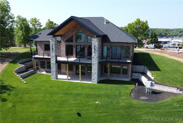 back of house with a lawn, a patio, and stone siding