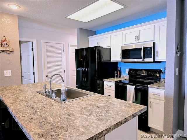 kitchen featuring white cabinets, a textured ceiling, black appliances, and a sink