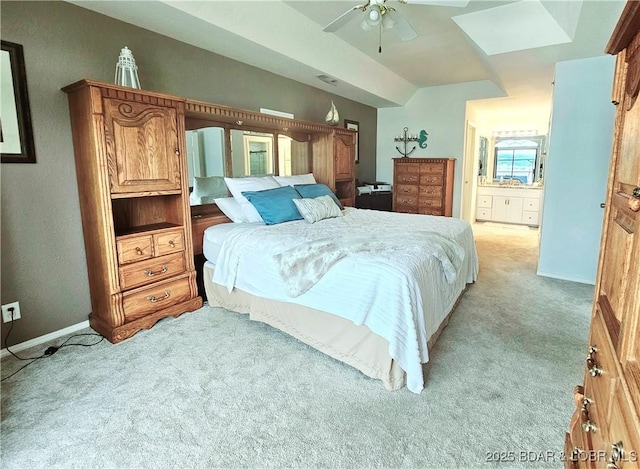 bedroom featuring connected bathroom, ceiling fan, baseboards, light colored carpet, and vaulted ceiling