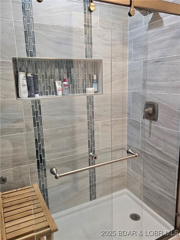 full bath featuring a shower stall