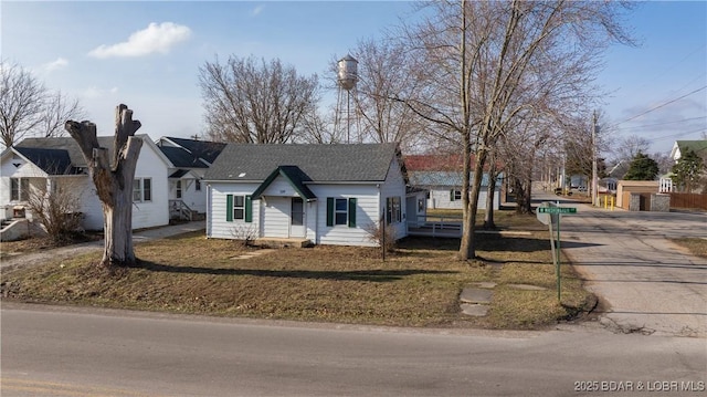 view of front facade with roof with shingles