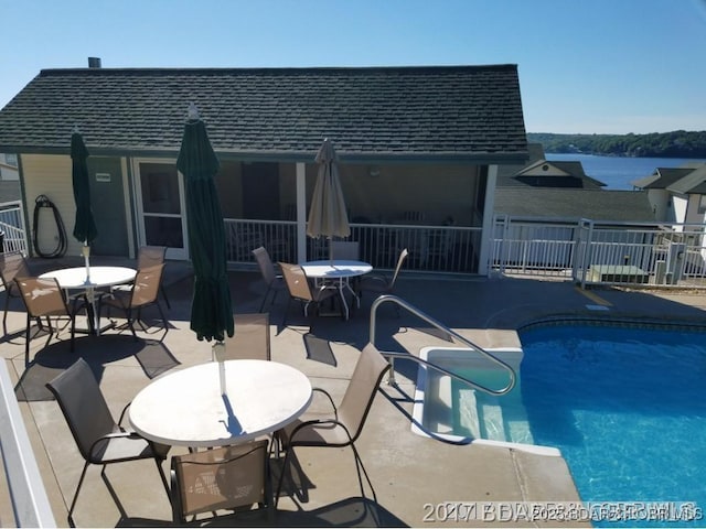 view of pool with outdoor dining area, a patio, a fenced in pool, and fence