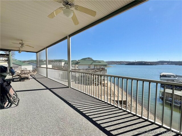 view of patio / terrace featuring a water view and ceiling fan