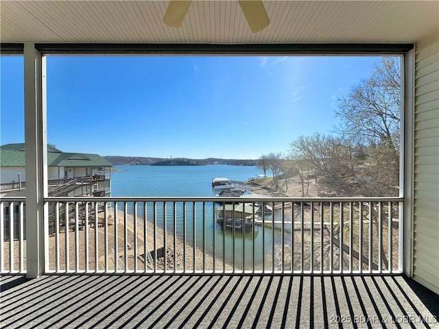 wooden deck featuring a water view and ceiling fan