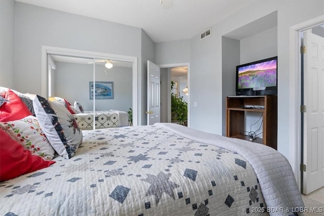 bedroom with a closet, ceiling fan, and visible vents