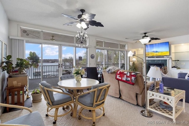 dining room with a fireplace and ceiling fan