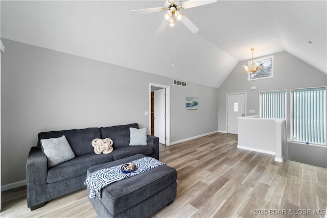 living area featuring lofted ceiling, light wood-style floors, ceiling fan, and baseboards