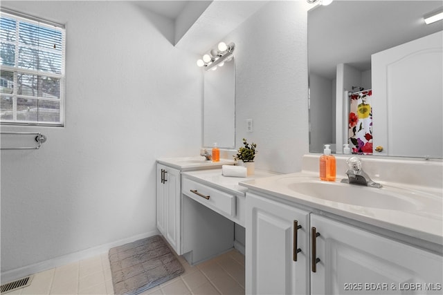 bathroom with double vanity, tile patterned floors, baseboards, and a shower with shower curtain