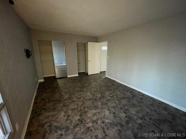 unfurnished bedroom featuring baseboards