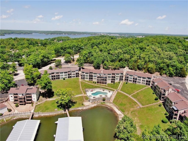 aerial view with a wooded view and a water view