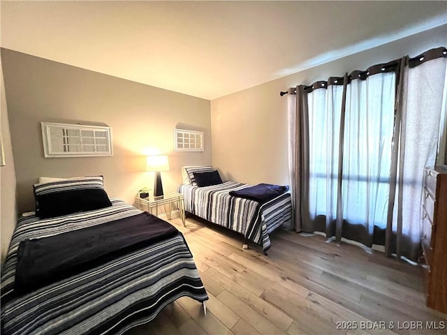 bedroom featuring light wood-style floors