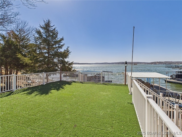 view of yard featuring a water view and fence