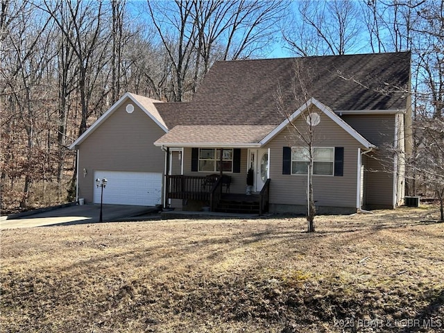 view of front of house with a porch, cooling unit, concrete driveway, a shingled roof, and a garage