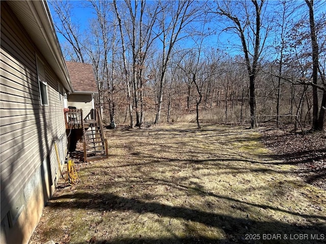 view of yard featuring a wooden deck and stairs