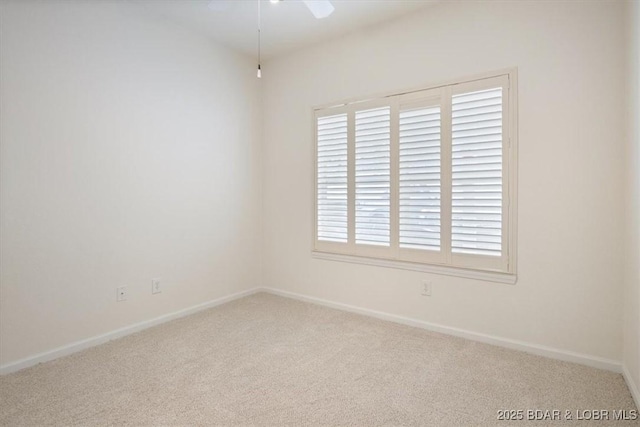 carpeted spare room with baseboards