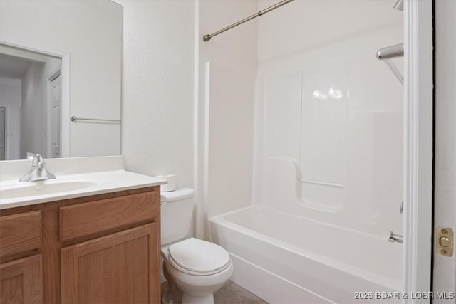 bathroom featuring vanity, toilet, and bathtub / shower combination