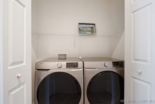 laundry area with separate washer and dryer and laundry area