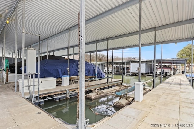 view of dock with boat lift and a water view