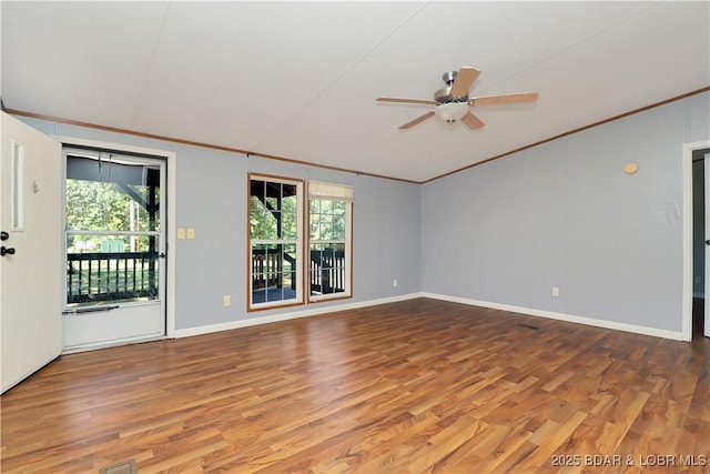 spare room featuring baseboards, wood finished floors, a ceiling fan, and ornamental molding