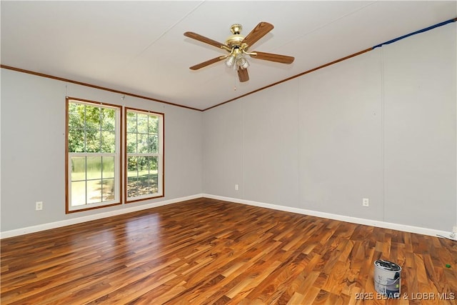 unfurnished room with baseboards, a ceiling fan, wood finished floors, and crown molding