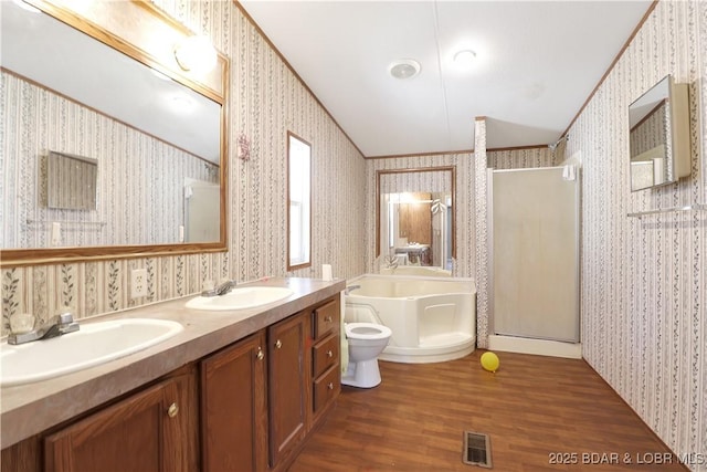 full bath with a sink, a shower stall, and wallpapered walls