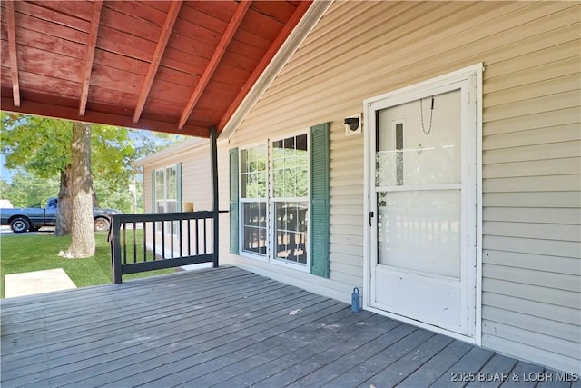 wooden terrace with a yard