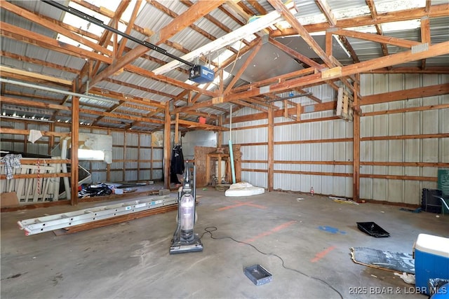 garage featuring a garage door opener and metal wall