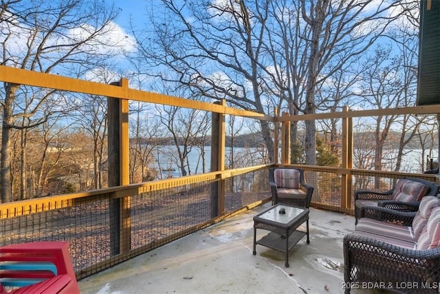 sunroom / solarium featuring a water view