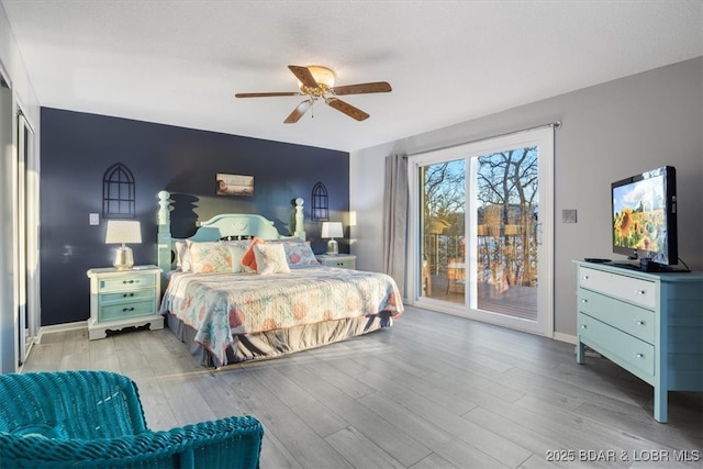 bedroom with ceiling fan, baseboards, wood finished floors, and access to outside